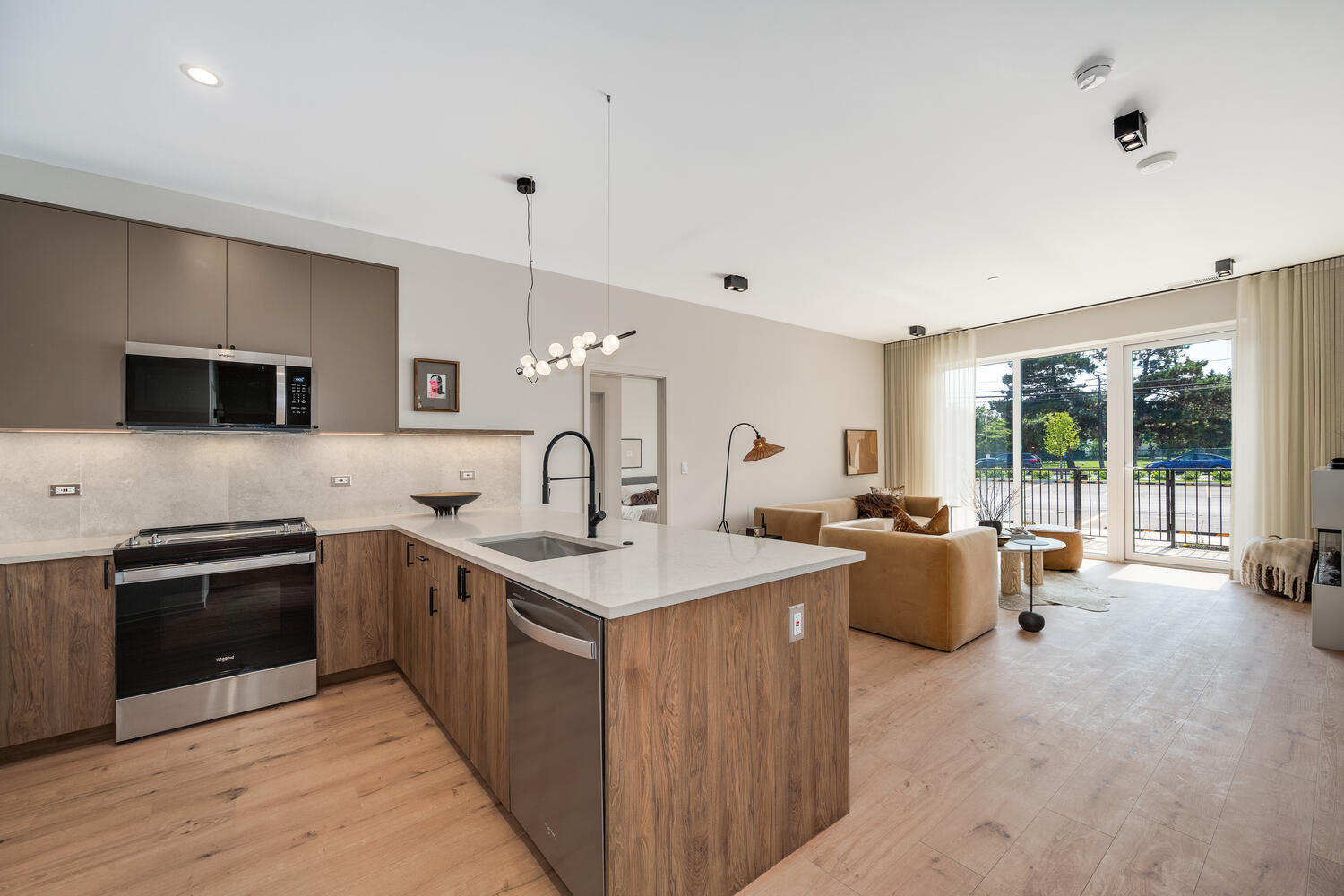 Open-concept living room and kitchen inside a Novú residence