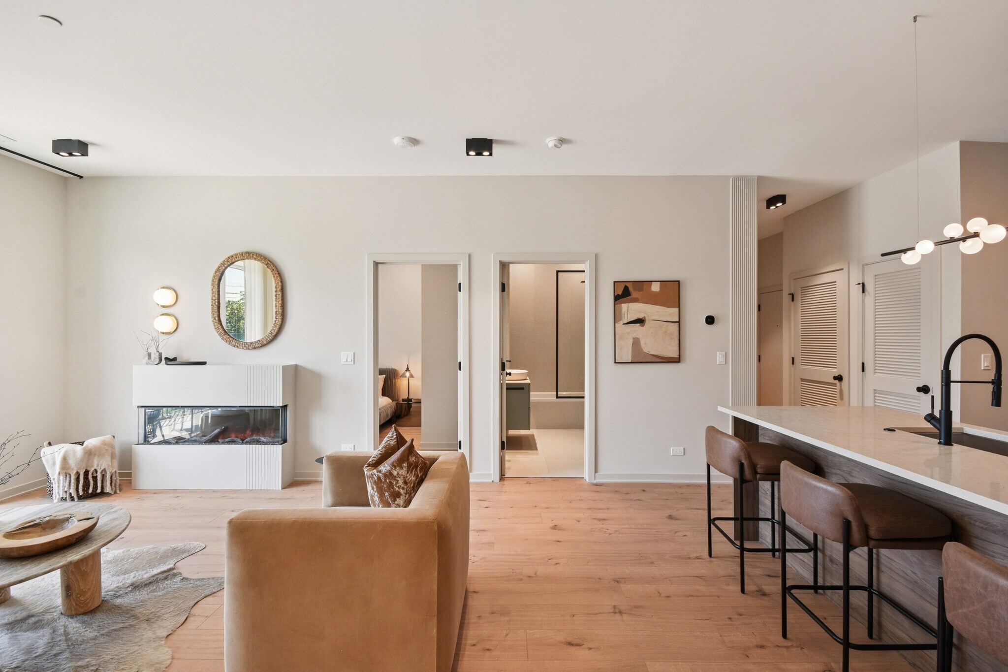 Residence living room with three-sided fireplace and kitchen island